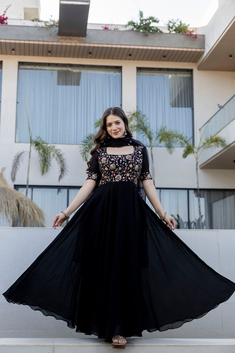 Woman wearing a black embroidered Anarkali gown with a designer dupatta by Pusti Feni